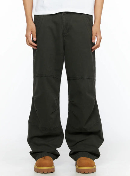 LEWKIN Men's Wide Leg Cargo Pants IL528 dark olive front close-up on model showing panel stitching and wide-leg silhouette with tan boots