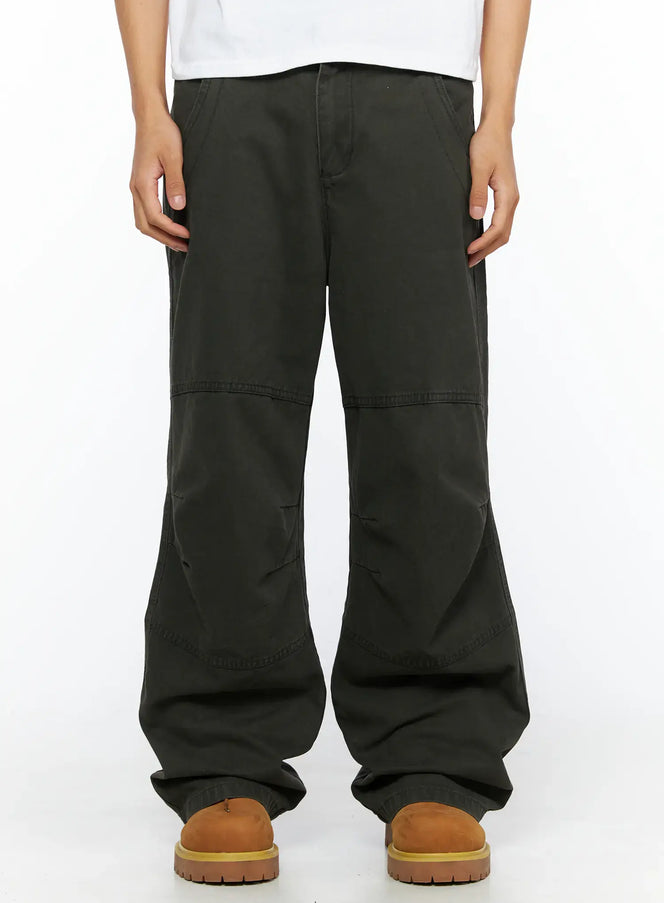 LEWKIN Men's Wide Leg Cargo Pants IL528 dark olive front close-up on model showing panel stitching and wide-leg silhouette with tan boots