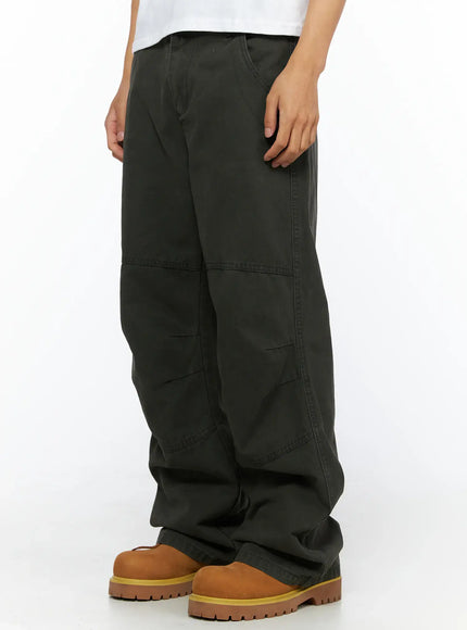Men's Wide Leg Cargo Pants IL528 dark olive side-angle close-up on model highlighting diagonal seam panels and wide leg cotton fabric