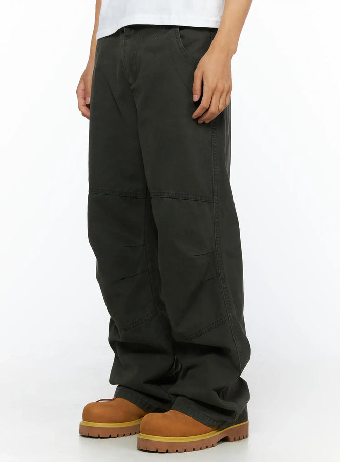 Men's Wide Leg Cargo Pants IL528 dark olive side-angle close-up on model highlighting diagonal seam panels and wide leg cotton fabric