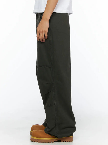 Men's Wide Leg Cargo Pants IL528 dark olive direct side view on model showing straight silhouette waistband and panel seam detail with tan boots