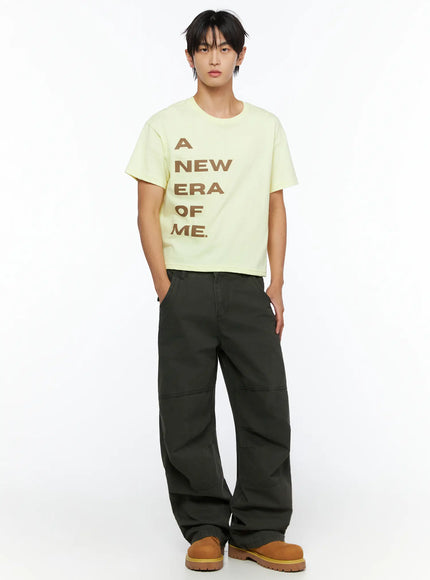Men's Wide Leg Cargo Pants IL528 dark olive full-body front view on male model styled with yellow graphic cropped tee and tan boots standing straight