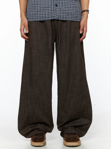 LEWKIN Men's Wide Leg Cotton Pants IL528 Dark brown front close-up on model showing drawstring waistband and wide-leg silhouette with linen-texture fabric