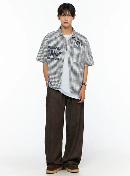 Men's Wide Leg Cotton Pants IL528 Dark brown full-body front shot on male model wearing plaid graphic shirt over white tee with hand in pocket
