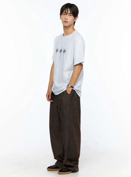 Men's Wide Leg Cotton Pants IL528 Dark brown full-body side shot on male model styled with white graphic tee hand in pocket three-quarter angle