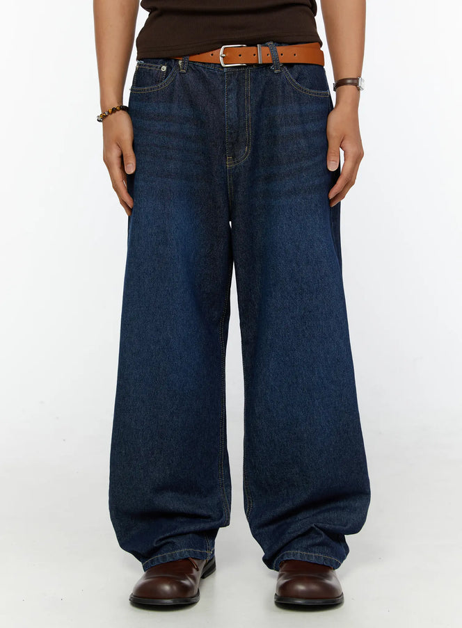 LEWKIN Men's Wide Leg Jeans IL515 dark blue front view on male model wearing brown top and tan leather belt with brown loafers