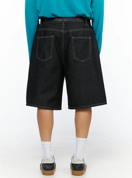 Men's Wide Leg Jorts IL528 Black back view on model showing dual back patch pockets with contrast stitching and black belt, styled with teal long-sleeve top