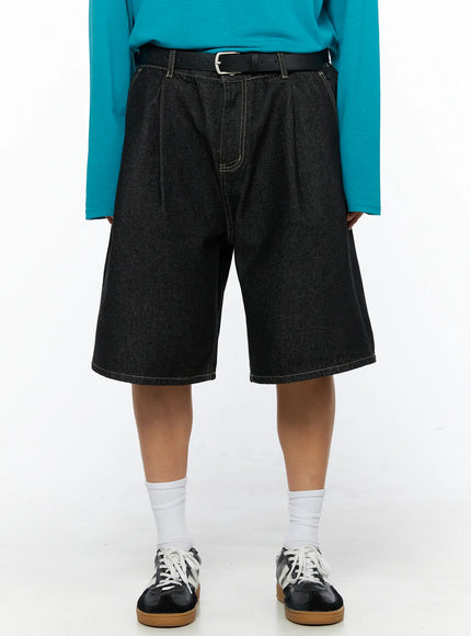 LEWKIN Men's Wide Leg Jorts IL528 Black front close-up on model showing pleated waistband, contrast stitching, and black leather belt, styled with teal top and sneakers