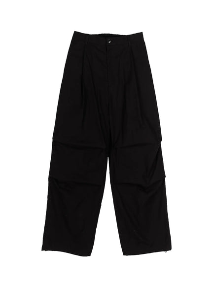 Men's Wide Leg Parachute Pants IL513 Black flat-lay front view showing single-button waistband, pleated front, cargo panel seams, wide leg cut, and hem drawcord loops
