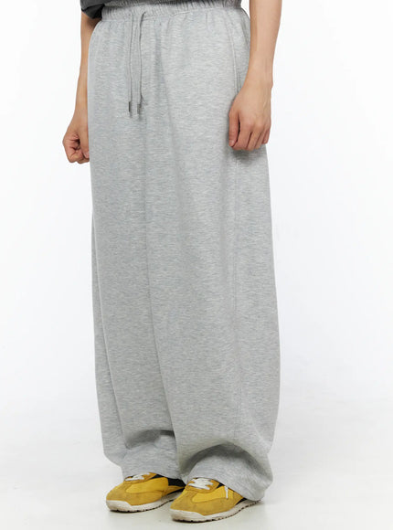 Men's Wide Leg Sweatpants IL510 Gray side shot on model showing drawstring elastic waistband and wide balloon leg with yellow sneakers styling