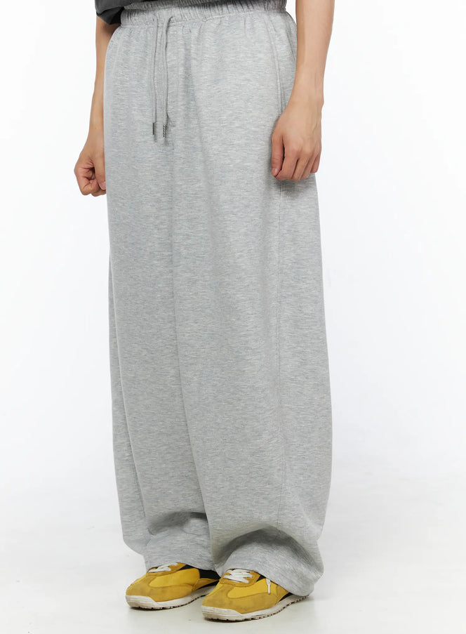 Men's Wide Leg Sweatpants IL510 Gray side shot on model showing drawstring elastic waistband and wide balloon leg with yellow sneakers styling