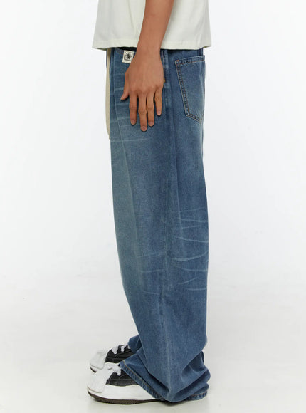 Men's Wide Leg Tie-Detail Jeans IL513 Blue side shot on model showing tapered wide-leg profile side pocket and label at waistband with sneakers