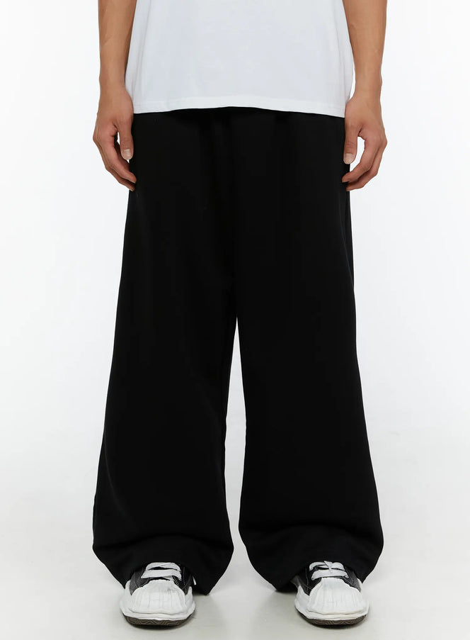 LEWKIN Men's Wide Sweatpants (Black) IL507 Black size M/L front shot on male model wearing white tee and sneakers, ultra wide-leg silhouette