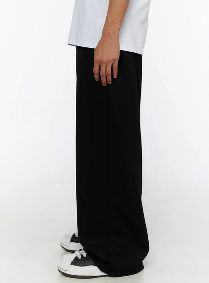 Men's Wide Sweatpants (Black) IL507 Black side shot on male model showing slim side profile, straight wide-leg cut and floor-grazing hem