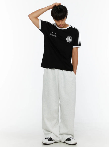 Men's Wide Sweatpants (Light Gray) IL507 Light gray full-body front shot on male model looking down, styled with graphic soccer tee and sneakers