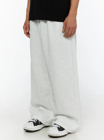 Men's Wide Sweatpants (Light Gray) IL507 Light gray side angle shot on model showing ultra-wide leg drape and stacked hem over sneakers