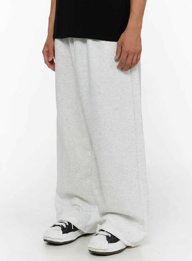 Men's Wide Sweatpants (Light Gray) IL507 Light gray side angle shot on model showing ultra-wide leg drape and stacked hem over sneakers