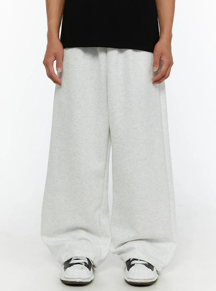 LEWKIN Men's Wide Sweatpants (Light Gray) IL507 Light gray front crop shot on model wearing black tee and sneakers, heathered fleece wide-leg silhouette