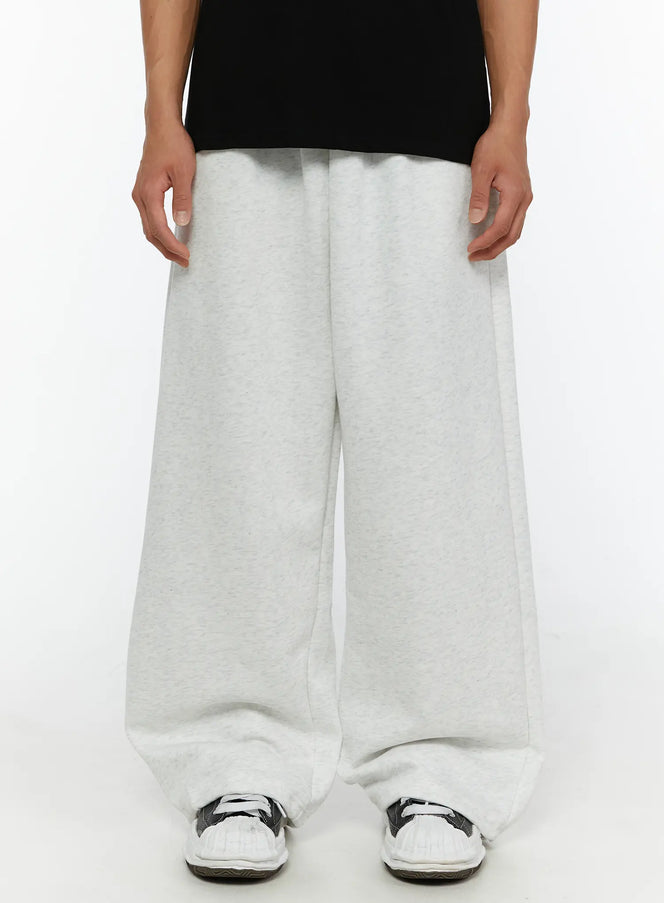 LEWKIN Men's Wide Sweatpants (Light Gray) IL507 Light gray front crop shot on model wearing black tee and sneakers, heathered fleece wide-leg silhouette