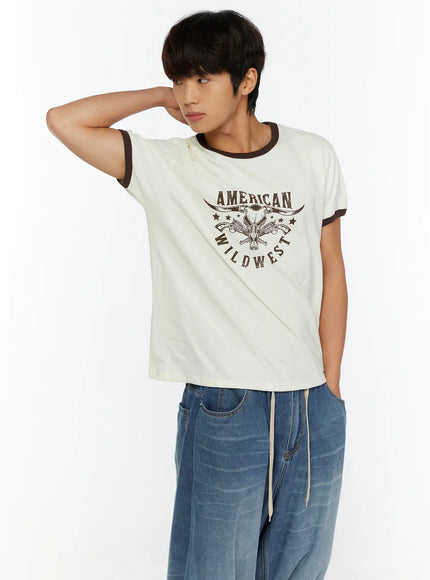 LEWKIN Men's Wild West Graphic T-Shirt IL513 Brown angled front view on male model hand behind head styled with wide-leg blue jeans