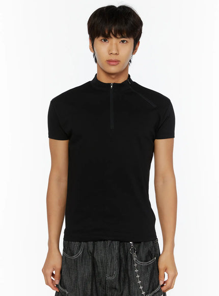 Men's Zip-Up Slim-Fit T-Shirt IL509 Black front shot on male model, half-zip mock neck closed, slim-fit short sleeve tee styled with dark wide-leg denim
