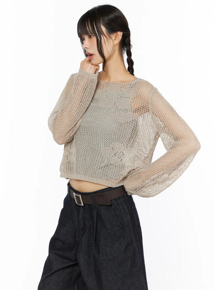 Mesh Knit Sweater CU530 Beige side view on model with braided pigtail hand to chin styled with dark denim wide-leg pants sheer mesh knit detail visible