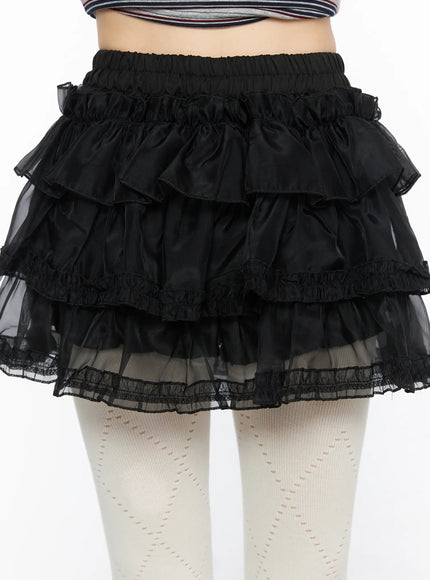 Mesh Tiered Mini Skirt CL522 Black detail close-up front shot on model showing elastic waistband three ruffle tiers sheer organza layer and lace trim hem