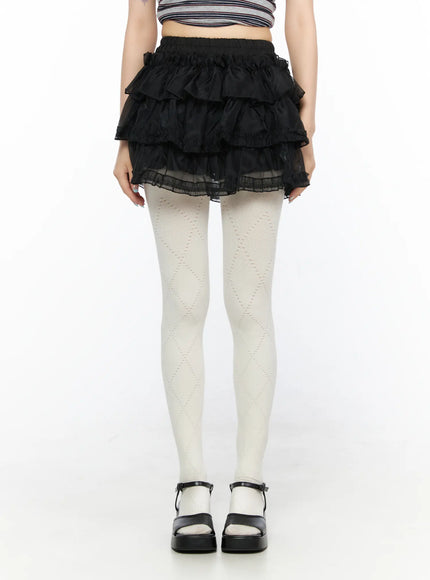 Mesh Tiered Mini Skirt CL522 Black front view on model standing straight showing full tiered ruffle skirt silhouette with sheer mesh hem and platform sandals