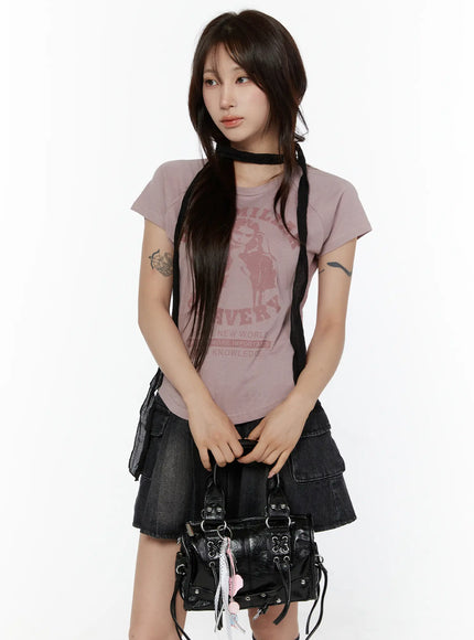 Metallic Detail Shoulder Bag CL508 Black model carrying bag at waist level styled with pink graphic tee and dark denim cargo skirt close-up shot