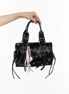 LEWKIN Metallic Detail Shoulder Bag CL508 Black front view held aloft by model's hand showing crinkled faux leather with silver hardware and pink charm tassel