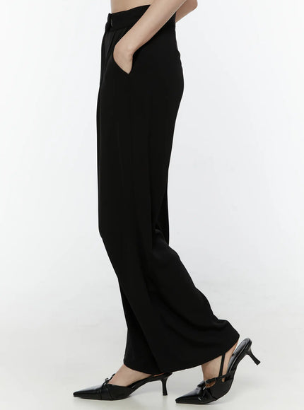 Mid-Rise Tailored Pants IL506 Black side view on model hand in pocket showing straight wide-leg silhouette high waistband and side pocket opening with black slingback heels