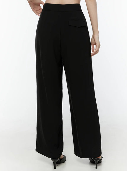 Mid-Rise Tailored Pants IL506 Black back view on model from waist down showing flap back pocket high-rise waistband clean back seam and wide-leg hem with black kitten heels