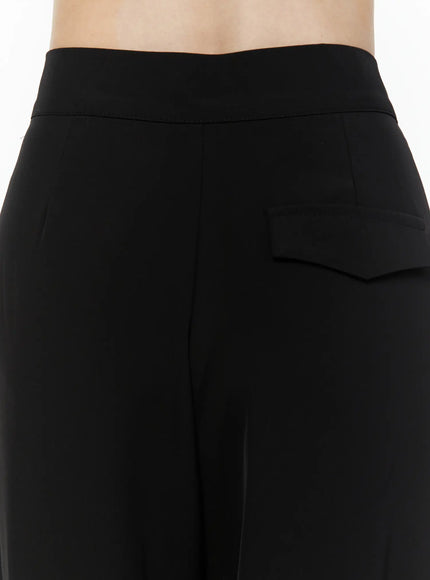Mid-Rise Tailored Pants IL506 Black close-up back detail showing structured flap back pocket high-rise waistband and smooth matte fabric texture on model