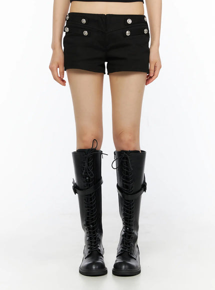 Military-Inspired Shorts CU530 Black front model shot from waist down emphasizing silver button rows and structured low-rise waistband