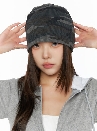 LEWKIN Military Style Beanie IL515 Dark gray front close-up on model hands adjusting waffle-knit camo beanie pulled low over eyes styled with gray hoodie