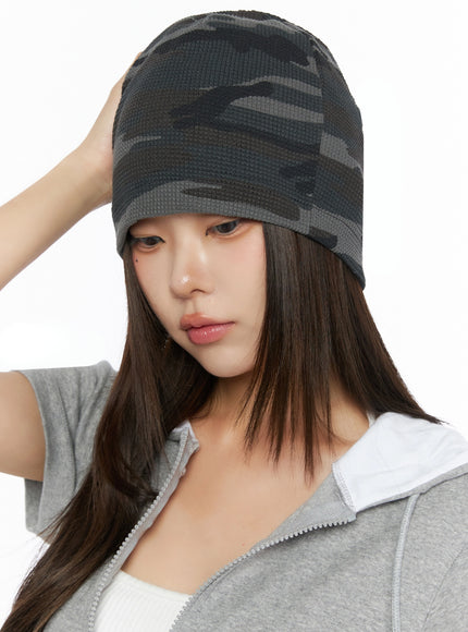 Military Style Beanie IL515 Dark gray close-up on model one hand touching beanie looking downward waffle-knit dark camo pattern with folded brim detail