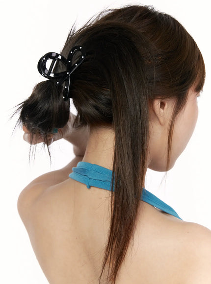 Mini Dot Hair Pin IL514 Black on-model back view securing low ponytail bun on brunette model wearing blue halter showing knot silhouette