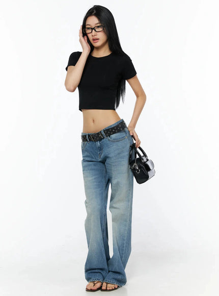 Miri Low Rise Straight Jeans IL509 Blue full-length front shot on model in black crop tee glasses holding black bag with star grommet belt