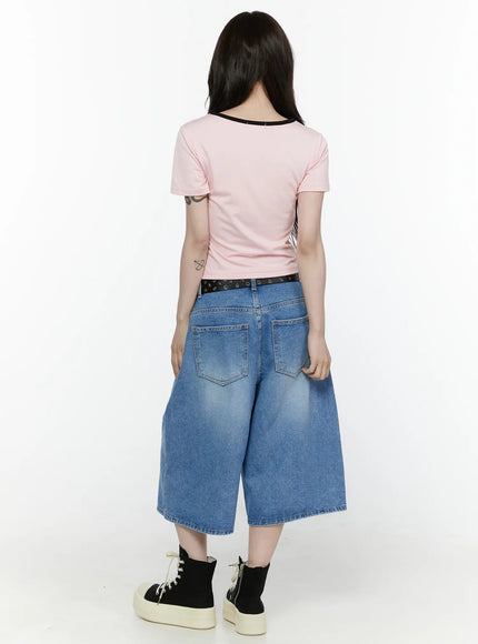 Miu Wide Leg Jeans IL521 Blue full-body back shot on model wearing pink crop tee and black belt revealing dual back pockets and wide hem with platform sneakers