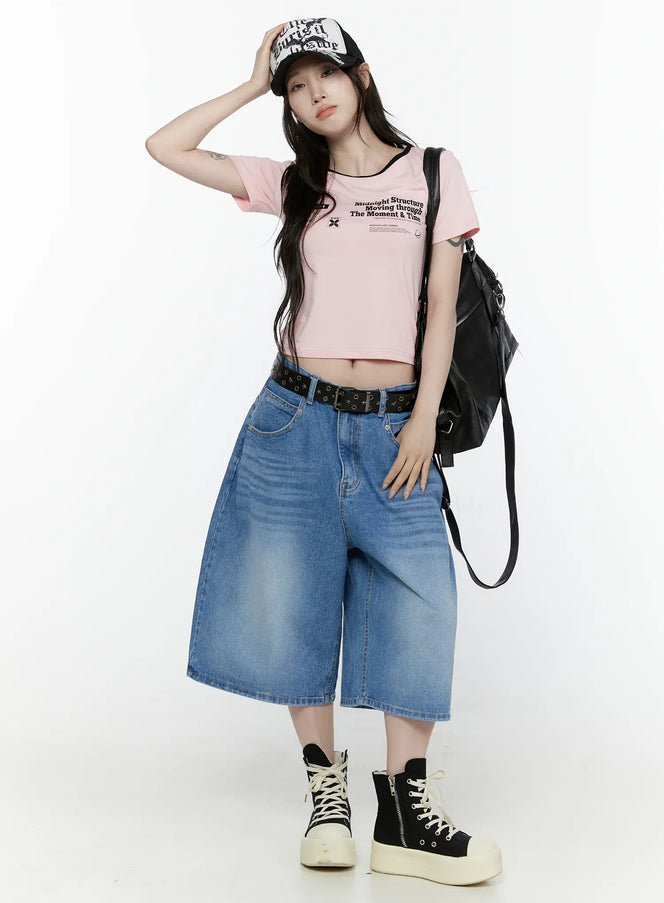 Miu Wide Leg Jeans IL521 Blue full-body front shot on model styled with pink crop tee graphic trucker cap black belt leather backpack and platform high-top sneakers