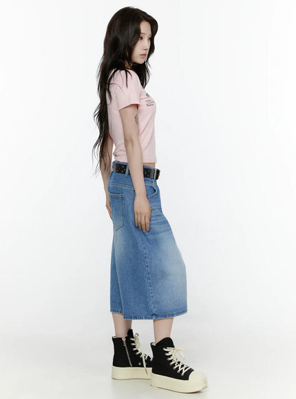 Miu Wide Leg Jeans IL521 Blue full-body side shot on model wearing pink crop tee and black studded belt showing wide-leg length and silhouette profile with platform sneakers