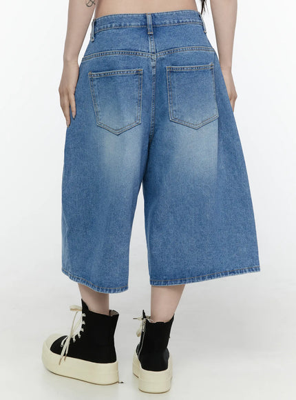 Miu Wide Leg Jeans IL521 Blue back close-up shot on model showing dual back pockets with stitched V-detail faded wash denim and wide-leg hem with platform sneakers