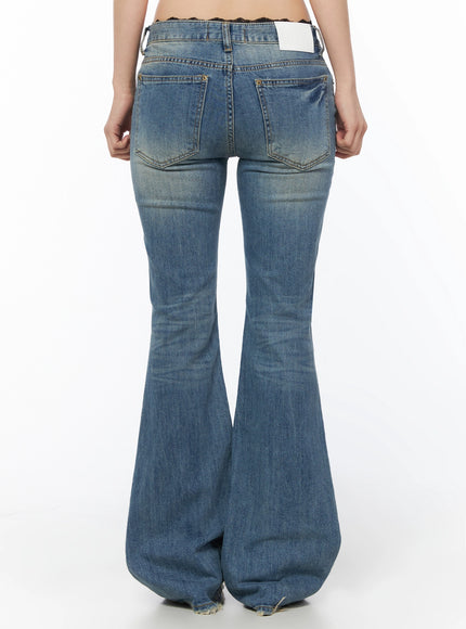 Moira Washed Low-Rise Bootcut Jeans IL502 Blue back cropped waist-to-thigh view on model, showing dual back pockets with brass rivets, label patch, lace waistband detail, washed denim