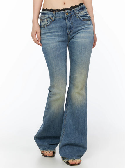 Moira Washed Low-Rise Bootcut Jeans IL502 Blue front cropped waist-to-ankle view on model, low-rise waistband with lace trim, vintage wash with yellow tinting on thighs, frayed hem