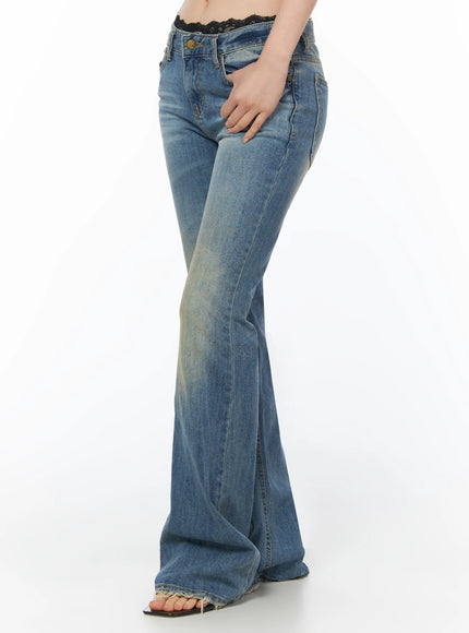 Moira Washed Low-Rise Bootcut Jeans IL502 Blue side view cropped waist-to-floor on model, hand in pocket, showing low-rise fit and wide flared leg silhouette with frayed hem