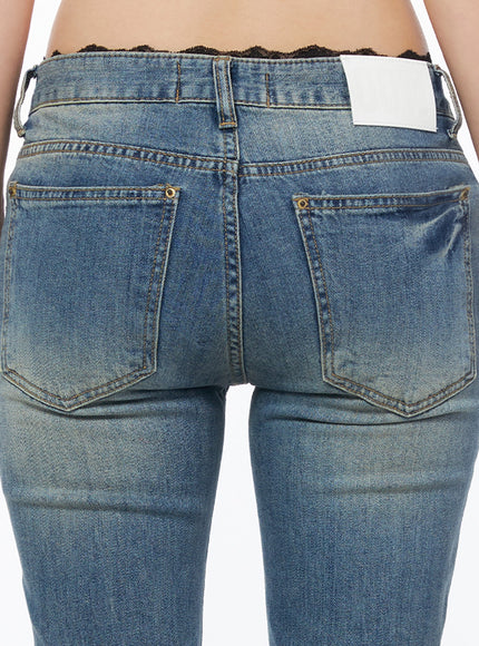 Moira Washed Low-Rise Bootcut Jeans IL502 Blue close-up back detail of rear pockets, brass rivets, contrast stitching, white label patch, and vintage wash on blue denim