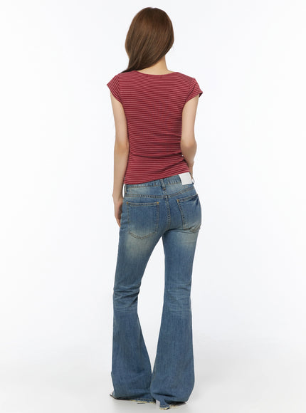 Moira Washed Low-Rise Bootcut Jeans IL502 Blue full-body back view on model wearing red striped top, showing back pockets, label patch at waist, and wide bootcut flare, white background