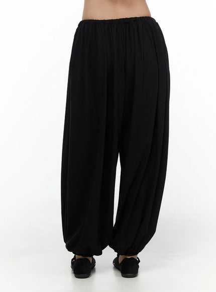 Multi-Purpose Balloon Sweatpants CL513 Black back shot on model showing gathered elastic waistband and draped balloon volume to ankle