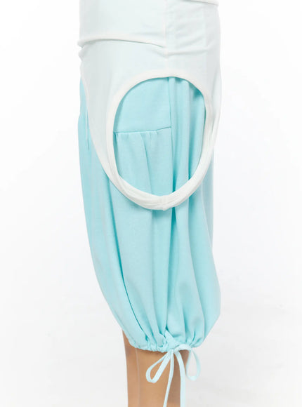 Multifunctional Ruched Sleeveless Top CL513 White detail close-up of light blue balloon pants featuring circular cut-out with white trim and gathered drawstring hem