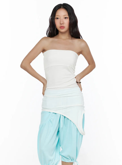 Multifunctional Ruched Sleeveless Top CL513 White front close-up shot on model showing strapless neckline and ruched waist detail layered over light blue asymmetric skirt waistband
